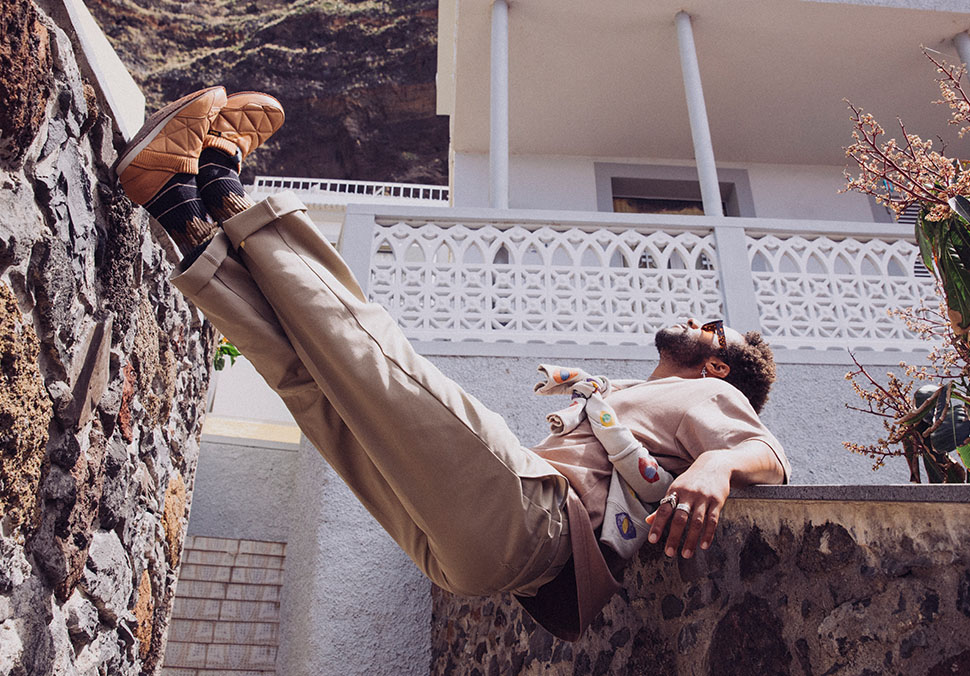 A person, balancing in a walkway, wearing Teva 'ReEmber' shoes.