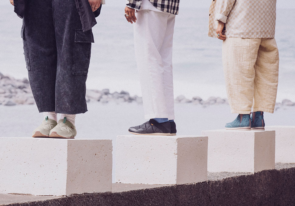 People are standing on concrete cubes and are wearing Teva 'ReEmber' shoes.