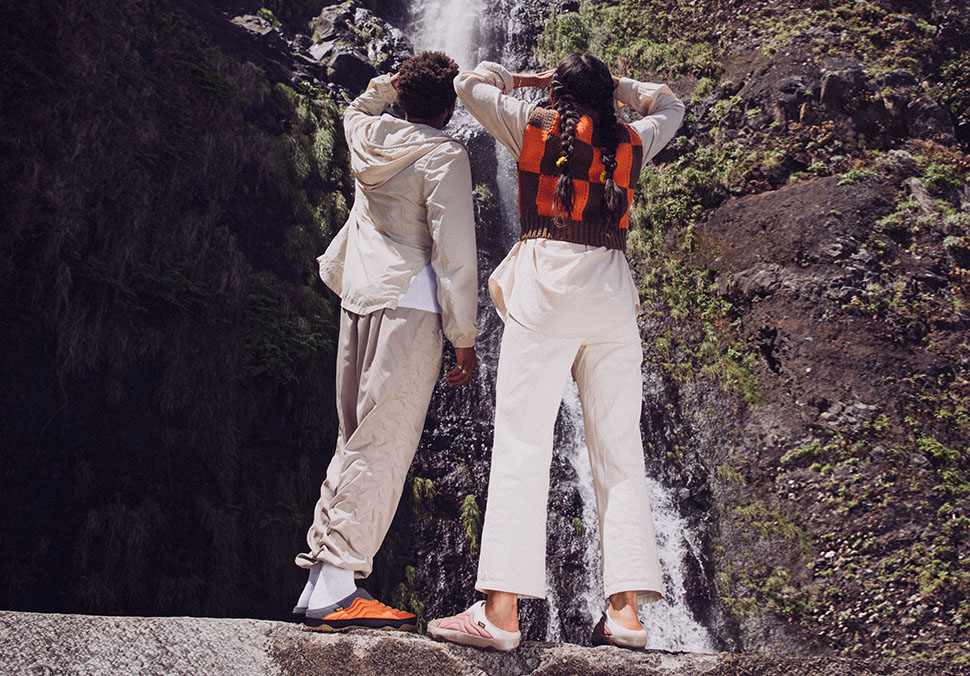 Two people looking up at a waterfall.