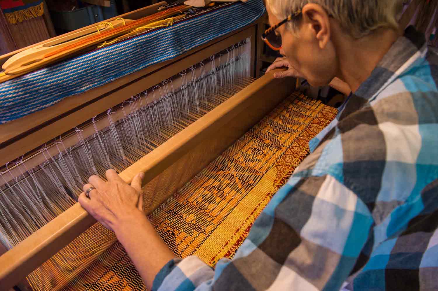 Picture of someone working at a loom.