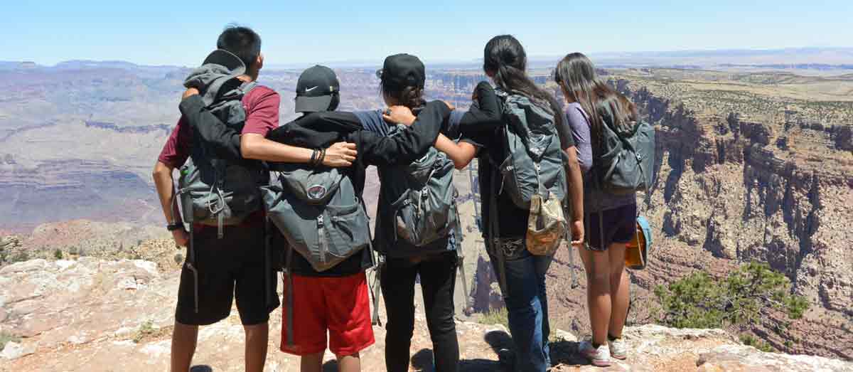 Picture of people standing in front of the Grand Canyon.
