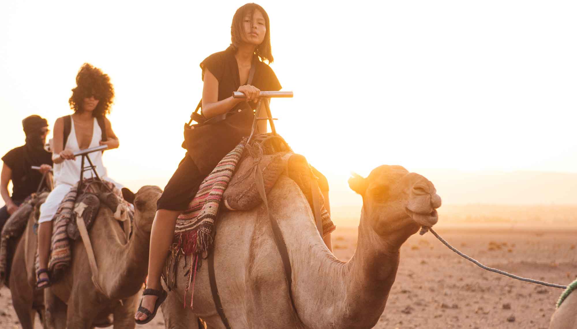 Picture of people riding camels.