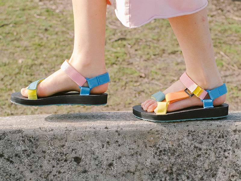 Close up of a kid's feet in Teva flip flops.