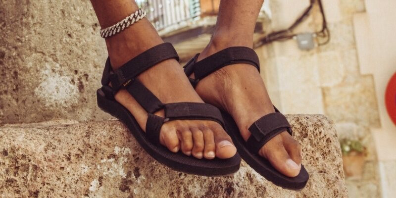 Close up of a person's feet wearing Teva sandals.