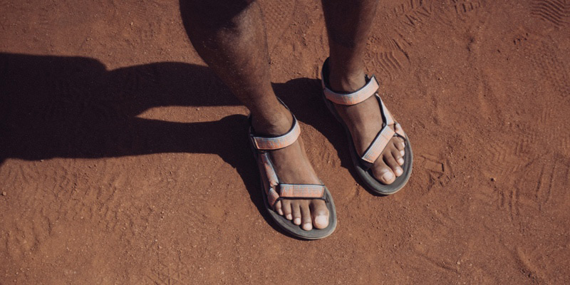 Close up of a person's feet wearing Teva Sandals.