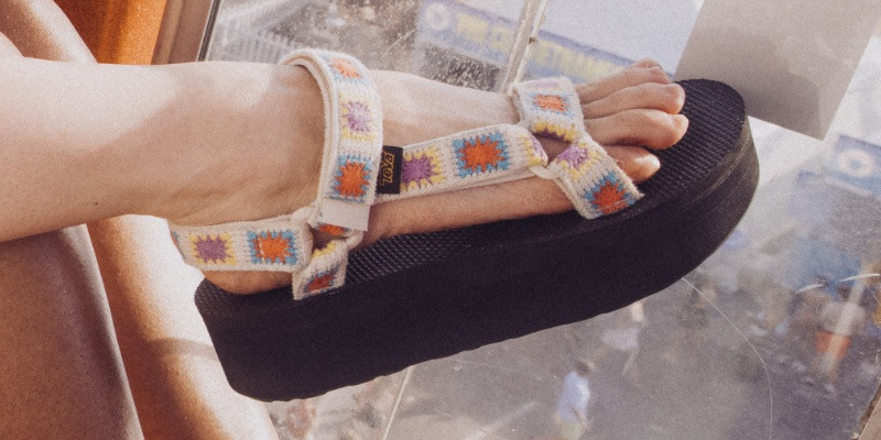 Close up of a person's foot wearing a Teva Sandal.