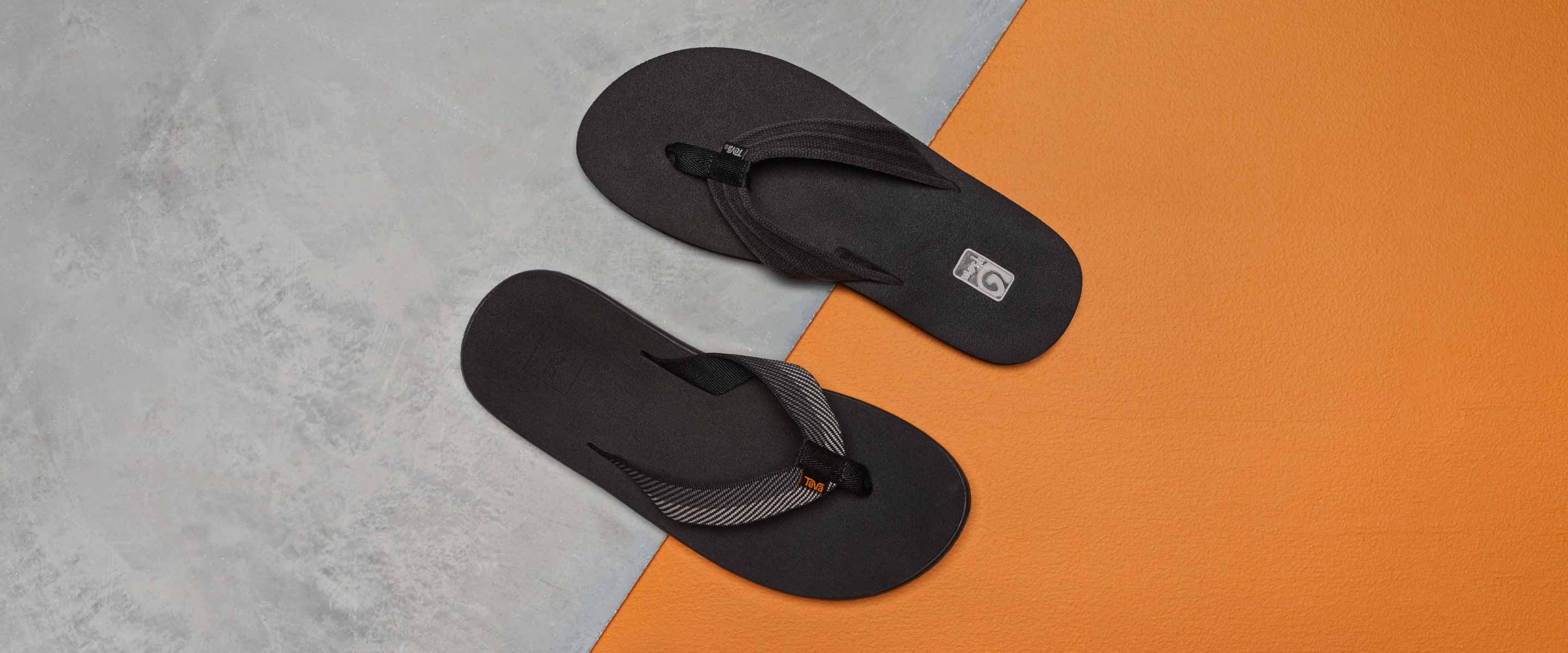 Teva flip flops against an orange and gray background.