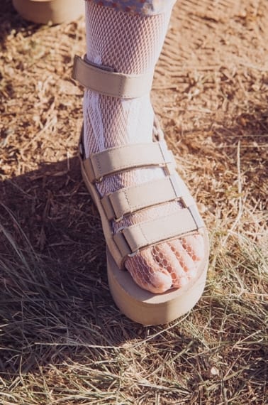 Close up of a person's feet wearing Teva sandals.