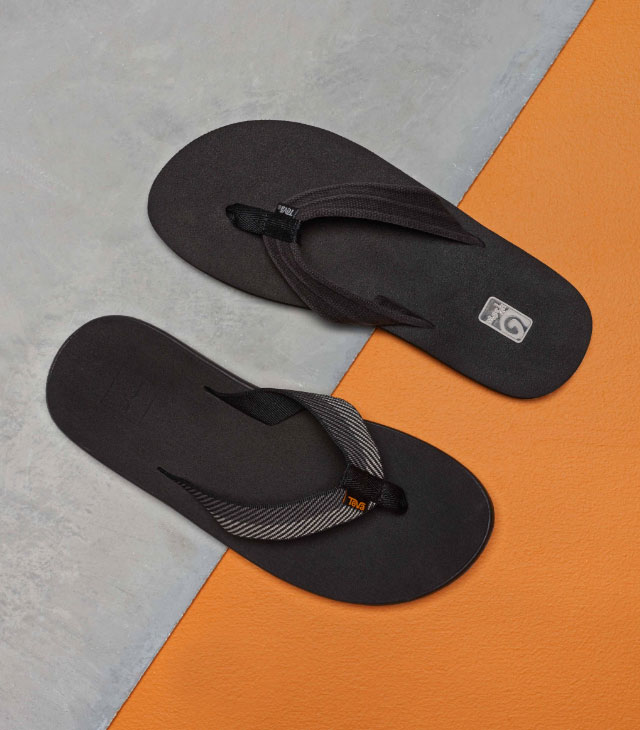 Teva flip flops against an orange and gray background.