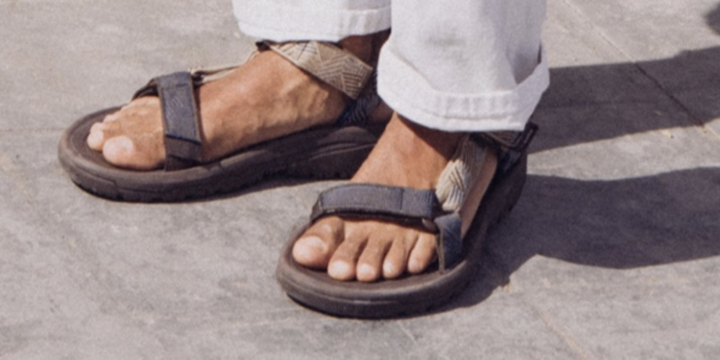 Close up of a person's feet wearing Teva Sandals.