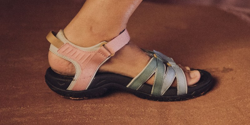 Close up of a person's foot wearing Teva footwear.