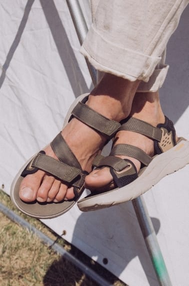 Close up of a person's feet wearing Teva sandals.
