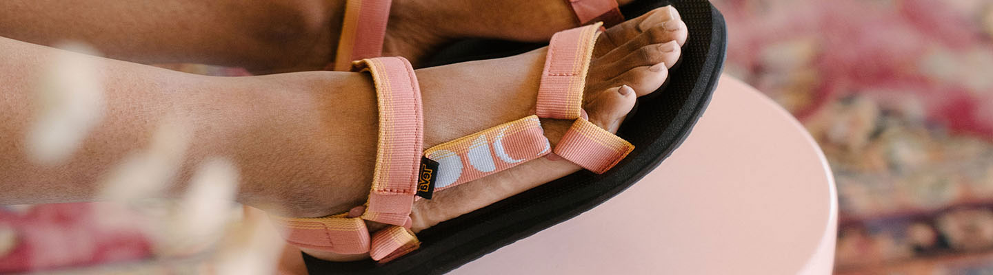 Close up of a woman's feet wearing Teva sandals.