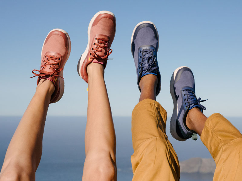Shoes Close up of man and woman's feet, hanging in the air, wearing Teva Shoes.