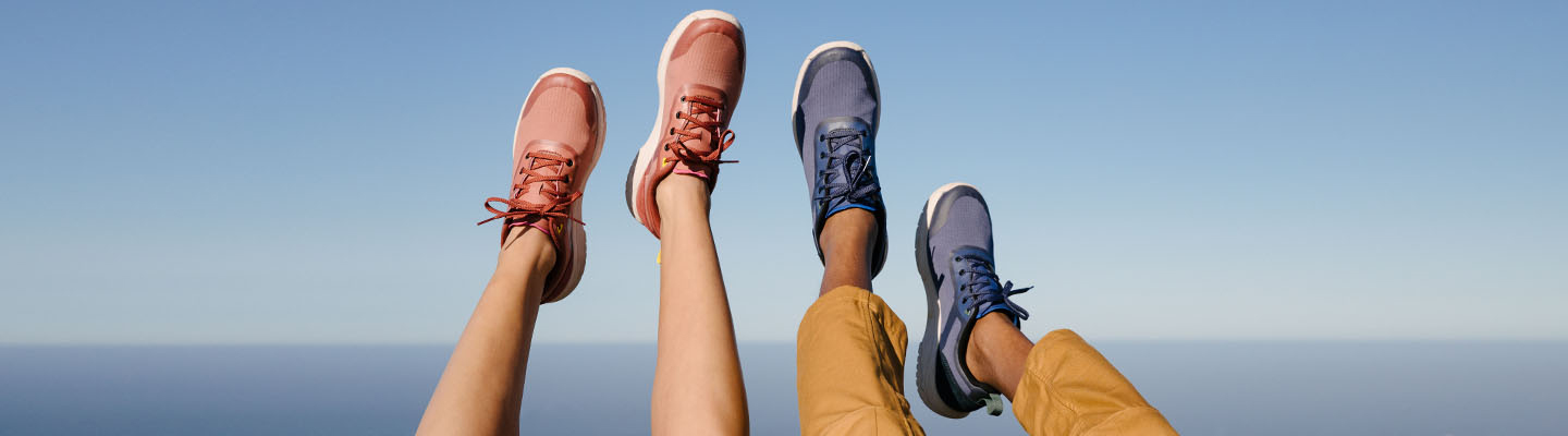 Shoes Close up of man and woman's feet, hanging in the air, wearing Teva Shoes.
